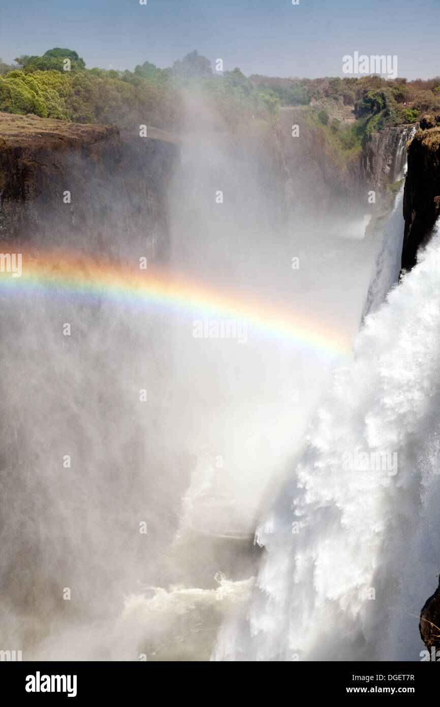 Victoria Falls with Rainbow, UNESCO World Heritage Site,  seen from Livingstone Island, Zambia side, Africa Stock Photo