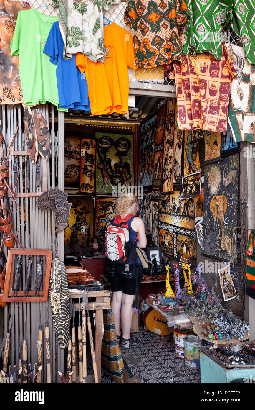 A female tourist shopping in a craft and curio shop, Livingstone town centre, Zambia Africa