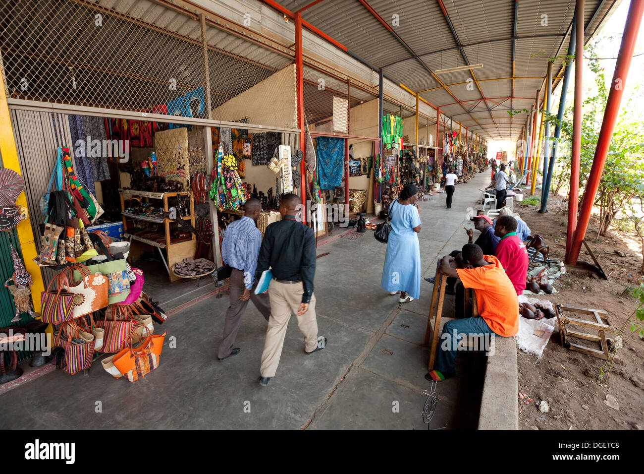 Street scene with local people, craft and curio shops, Livingstone town centre, Zambia Africa Stock Photo