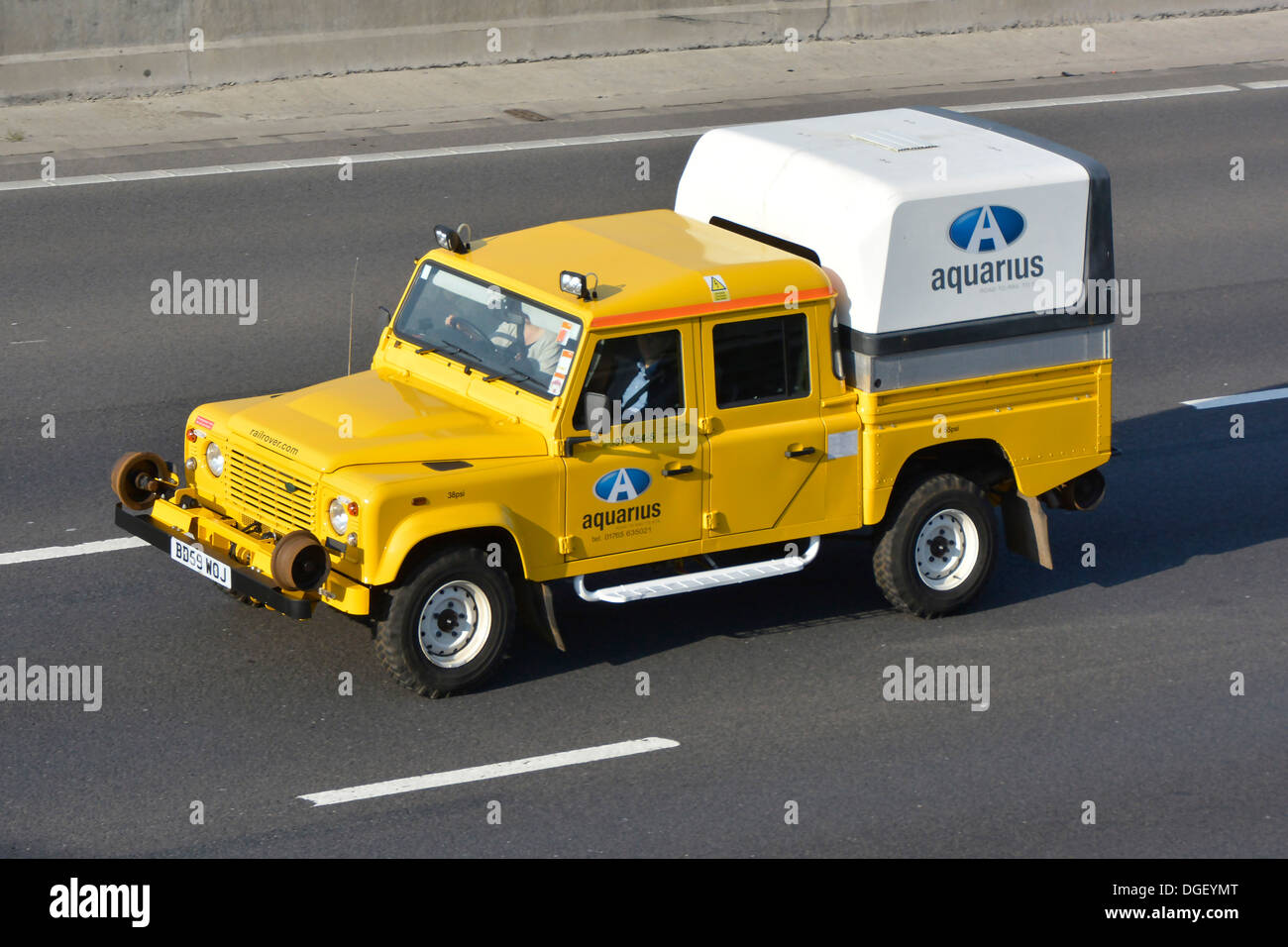 Land Rover truck converted to dual road rail use driving along motorway Stock Photo