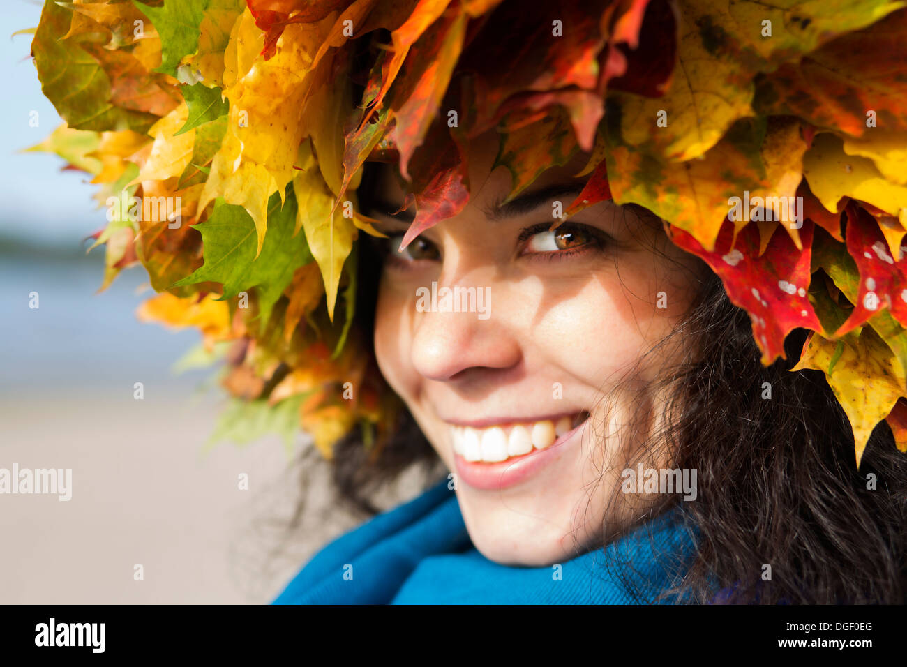 Zoomed smiling woman with maple leaves on head Stock Photo - Alamy