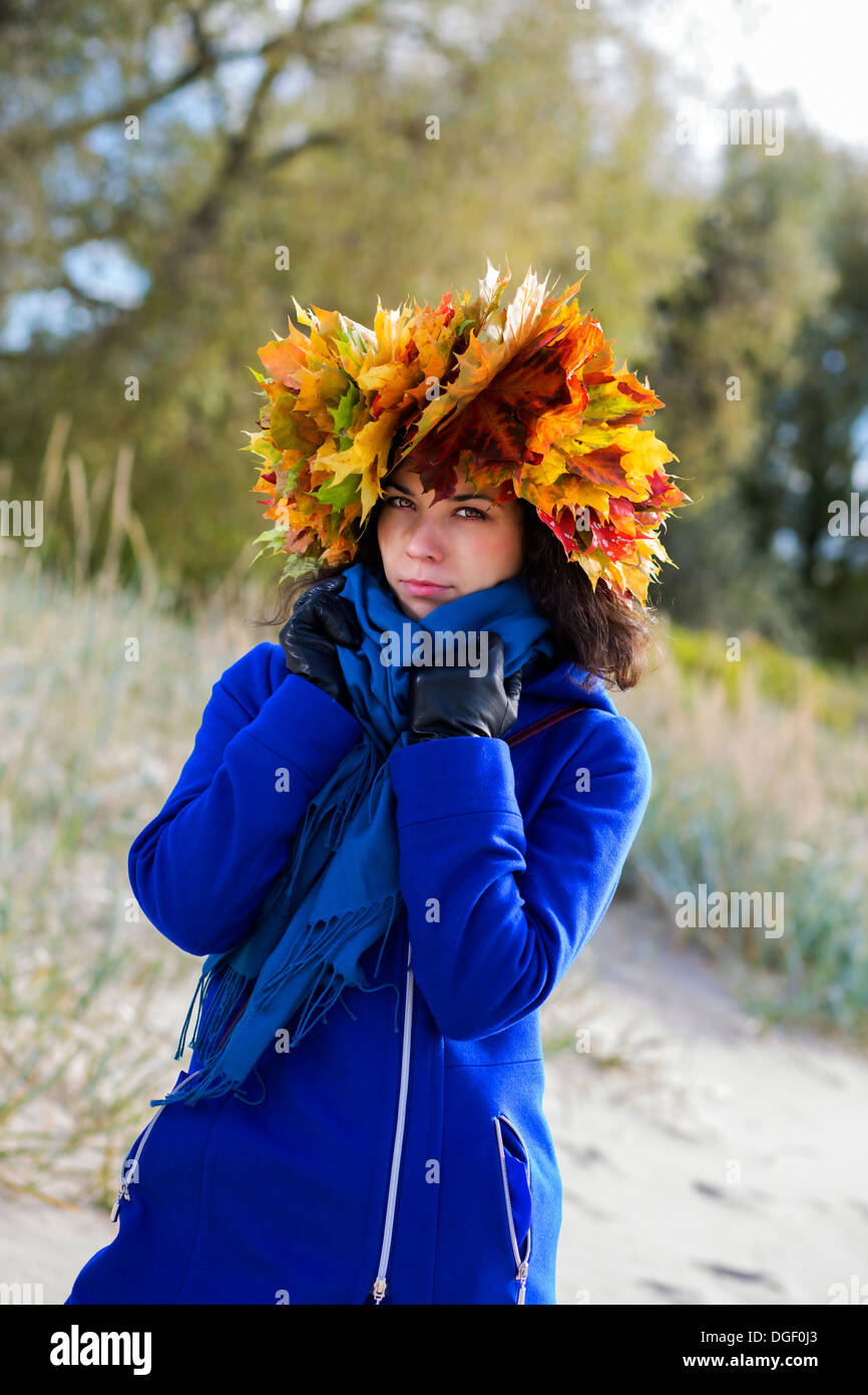 Woman feel cold while walking at autumn park Stock Photo