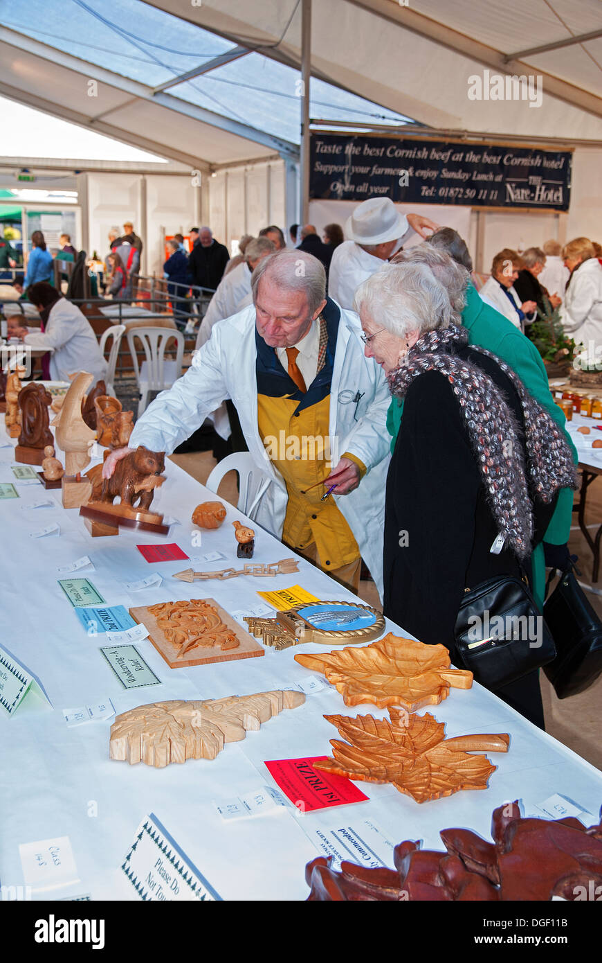 a judge looking at the exhibits at a craft fair in truro, cornwall, uk Stock Photo
