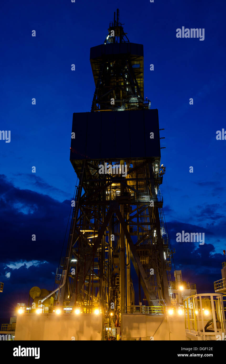 drill tower of the ultra deep waters drilling vessel Ocean Rig Mykonos, twilight, working in Brazil for Petrobras Stock Photo