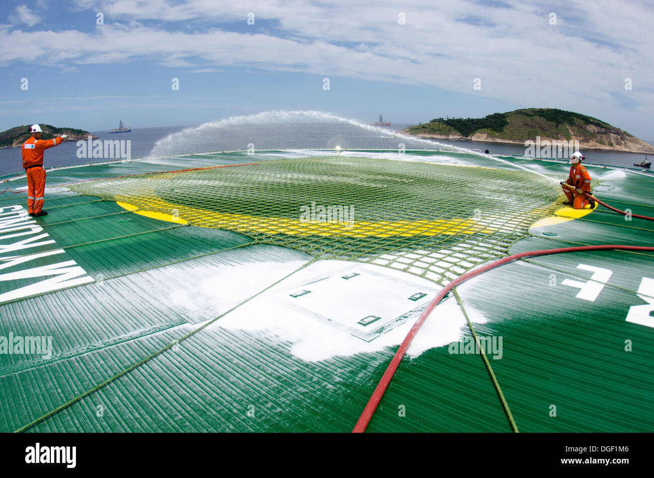 Oil rig crew members checking the foam cannons at the helicopter ...
