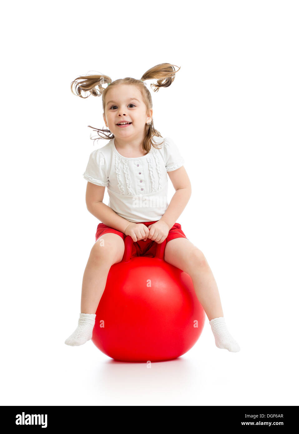 happy kid girl jumping on bouncing ball Stock Photo