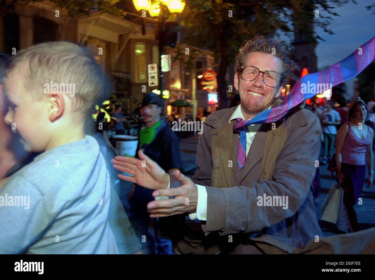 Zany street artist with a permanently windblown necktie walking in downtown Montreal during the Just for Laughs festival. Stock Photo