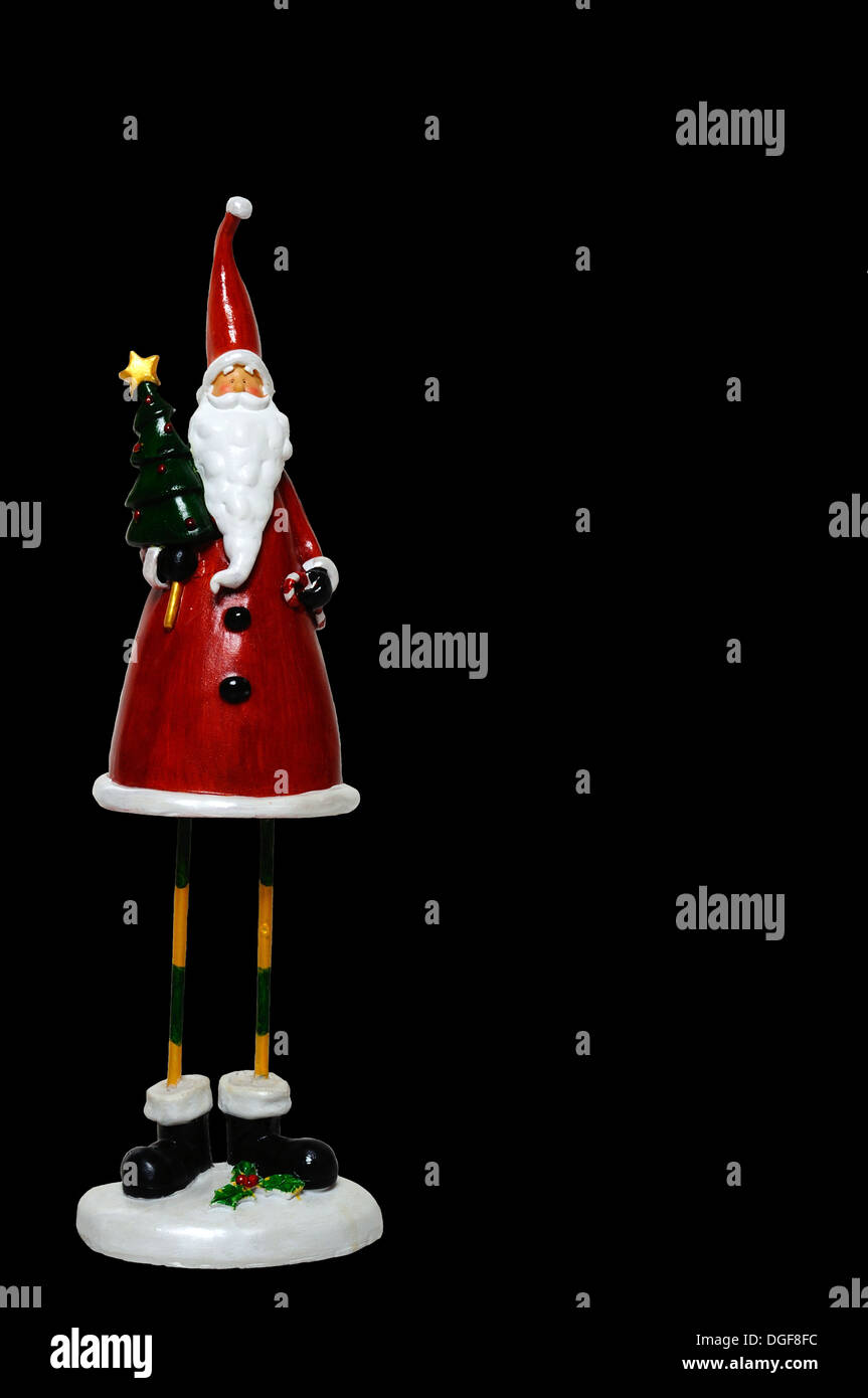 Father Christmas statue against a black background Stock Photo Alamy