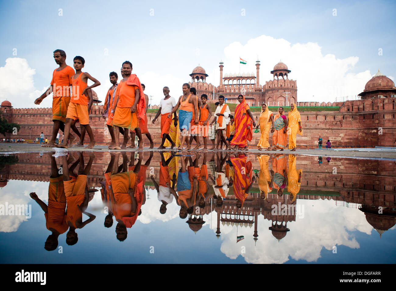 Group of people reflected in water outside The Red Fort in Delhi India Stock Photo