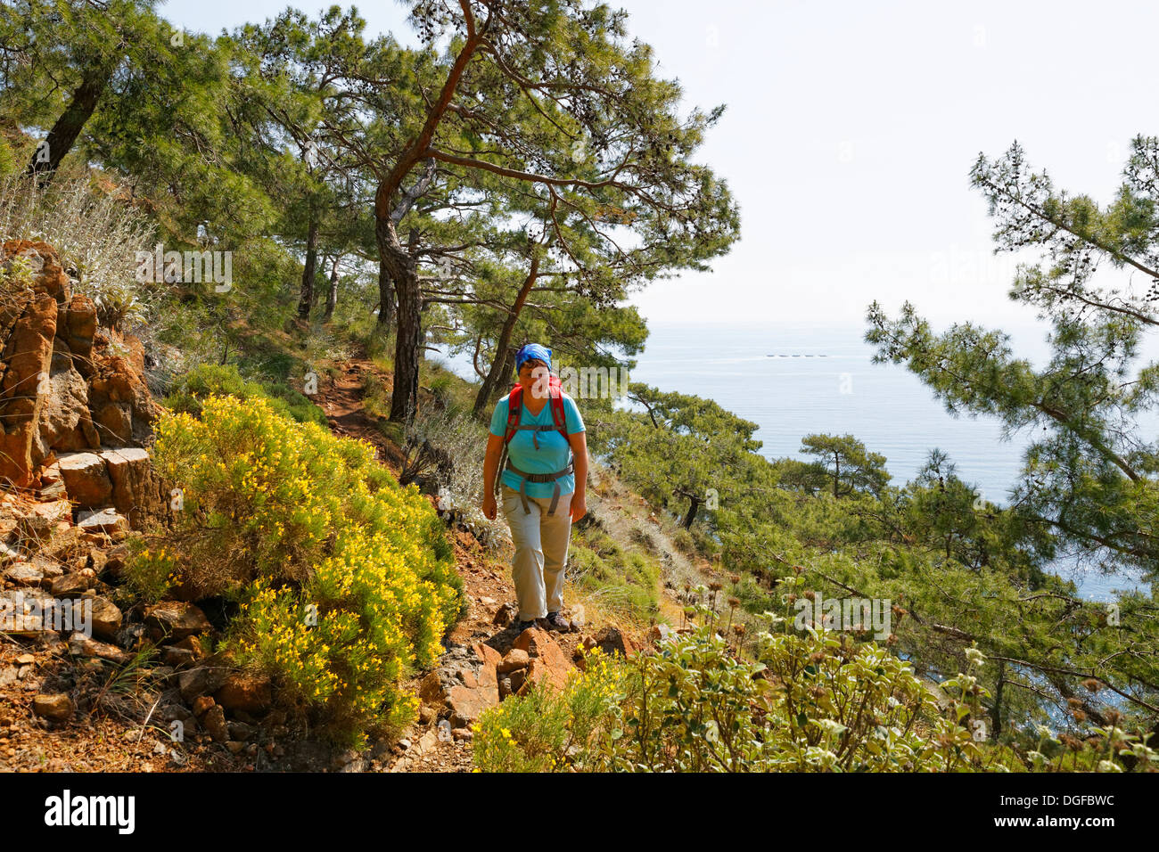 Woman with backpack hiking, Lycian Way, Lycian Coast, Olimpos Beydağları National Park, Çıralı, Lycia, Province of Antalya Stock Photo