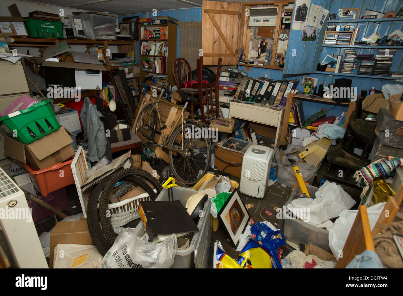 Hoarding is a type of behavior characterized by acquiring and failing to throw out a large number of items Stock Photo
