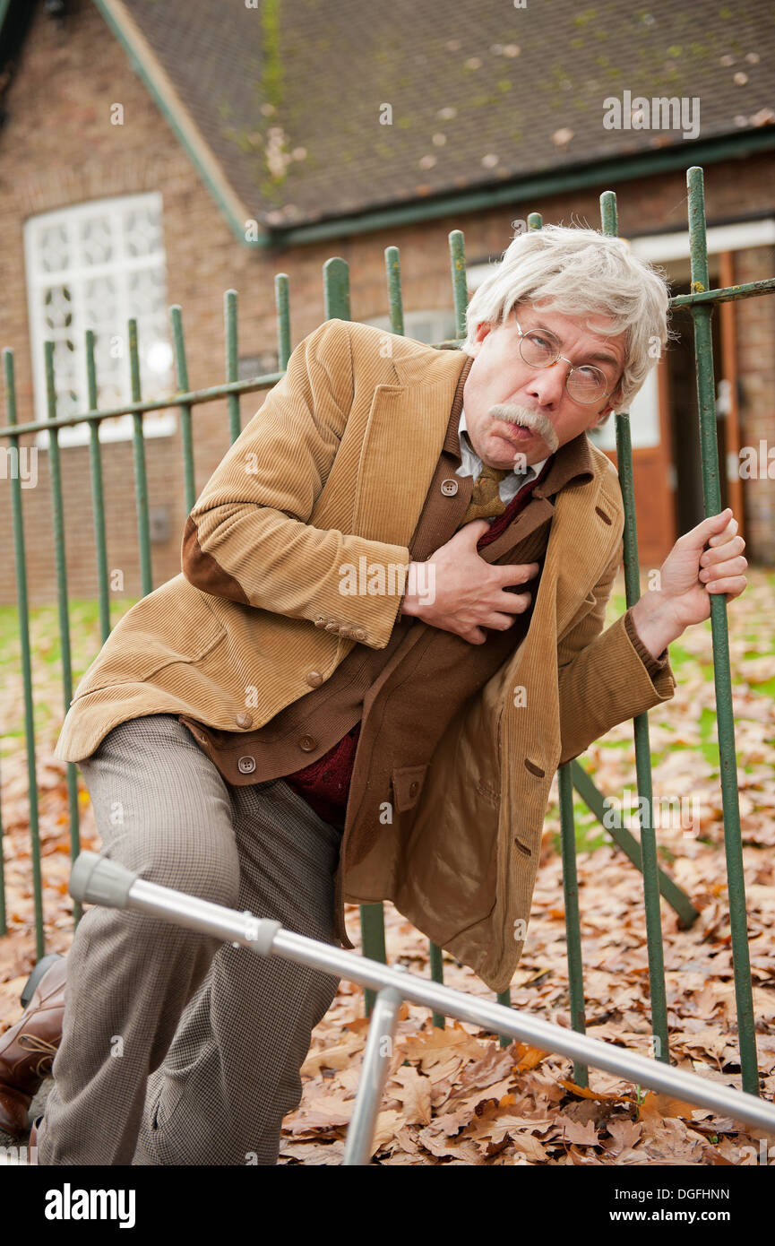 Old man collapsing in the street with chest pains. His Zimmer frame has