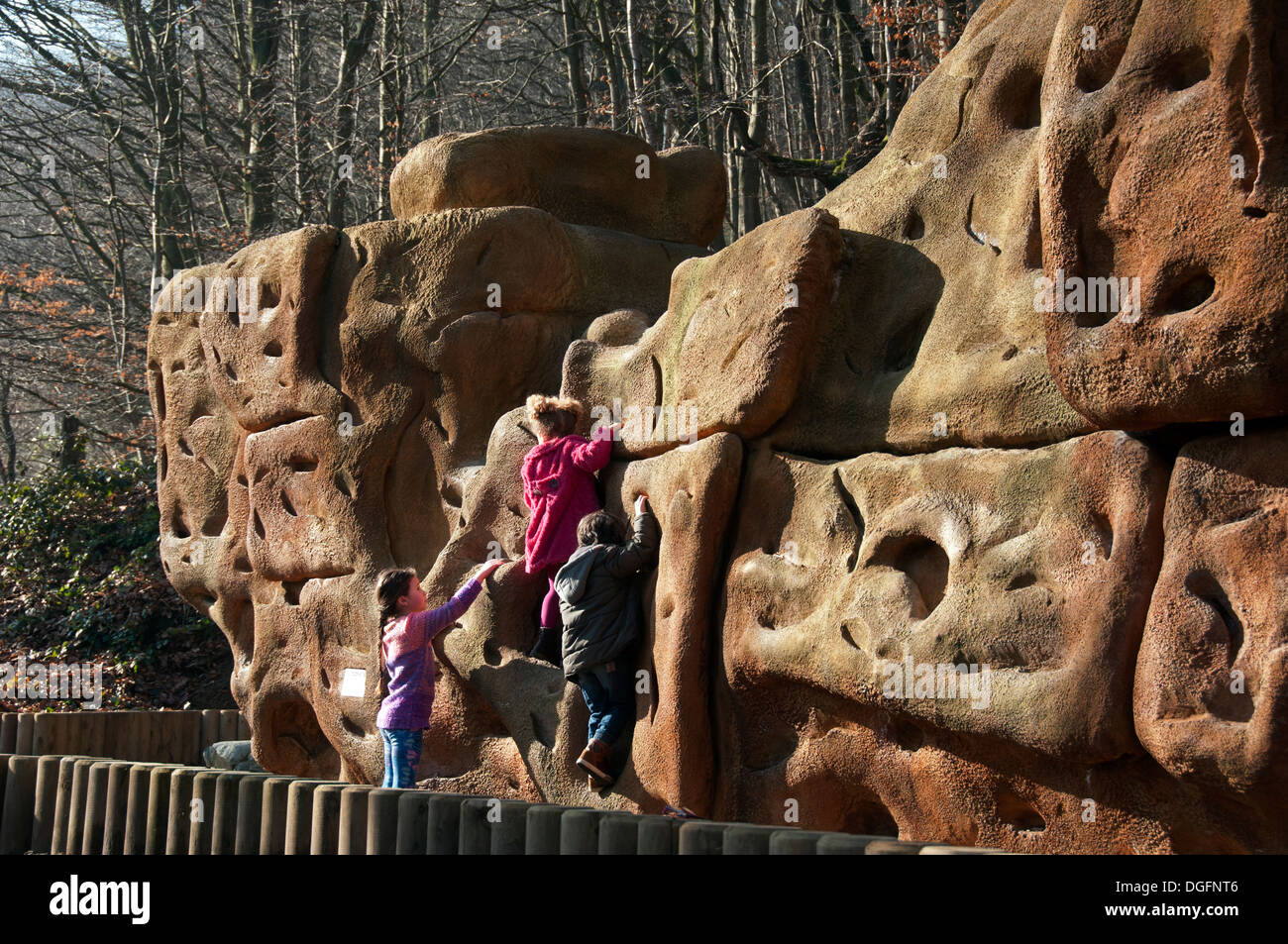 Children playing on an artificial climbing boulder at Dunwood Park, Shaw & Crompton, Oldham, Greater Manchester, England, UK Stock Photo