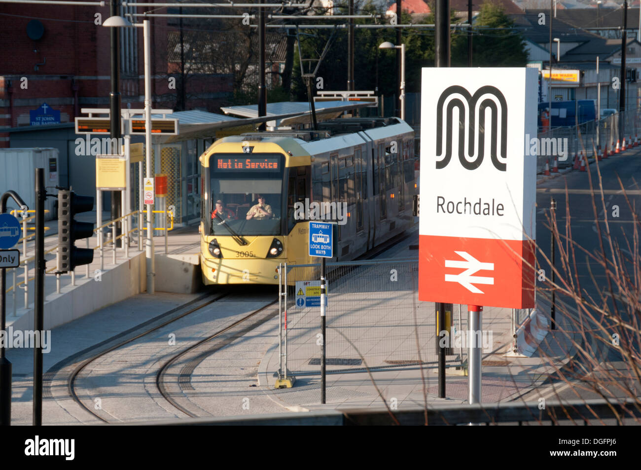 Metrolink tram at the Railway Station stop at Rochdale, Manchester, England, UK. Rail station sign in foreground. Stock Photo