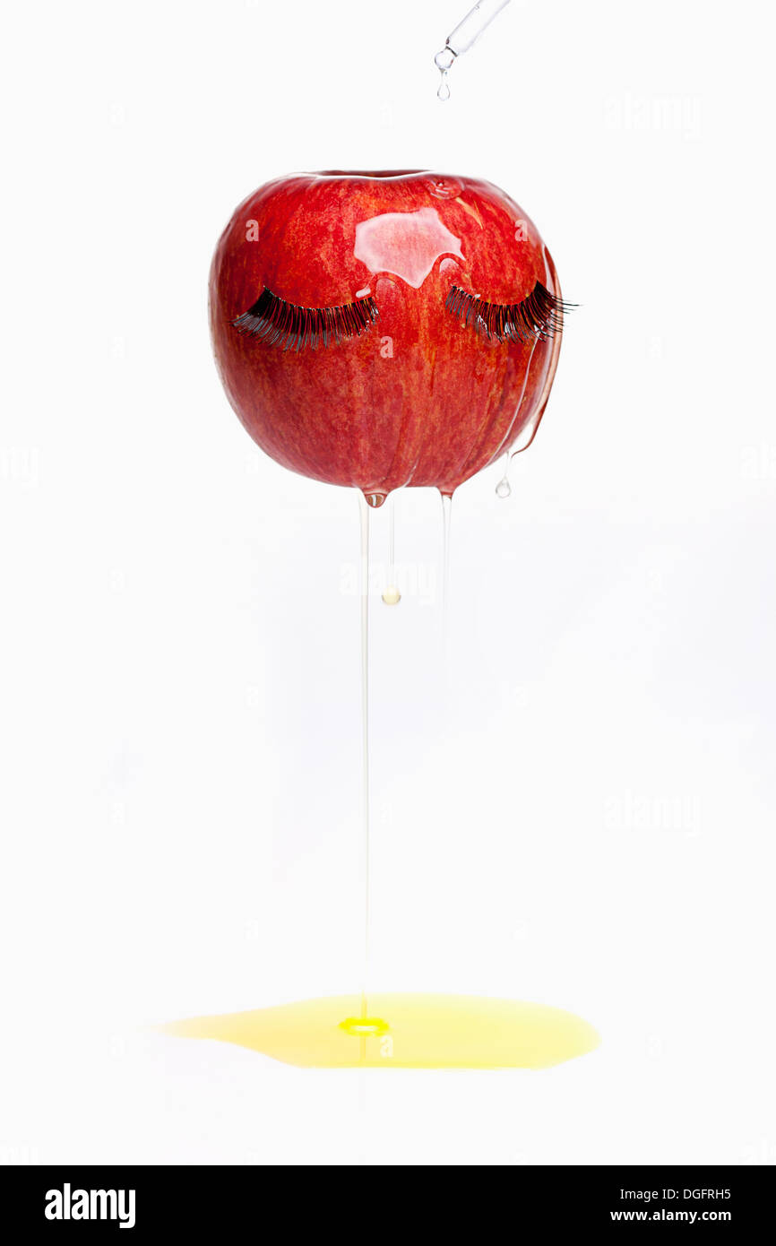 an image of an apple having fake eye lashes Stock Photo