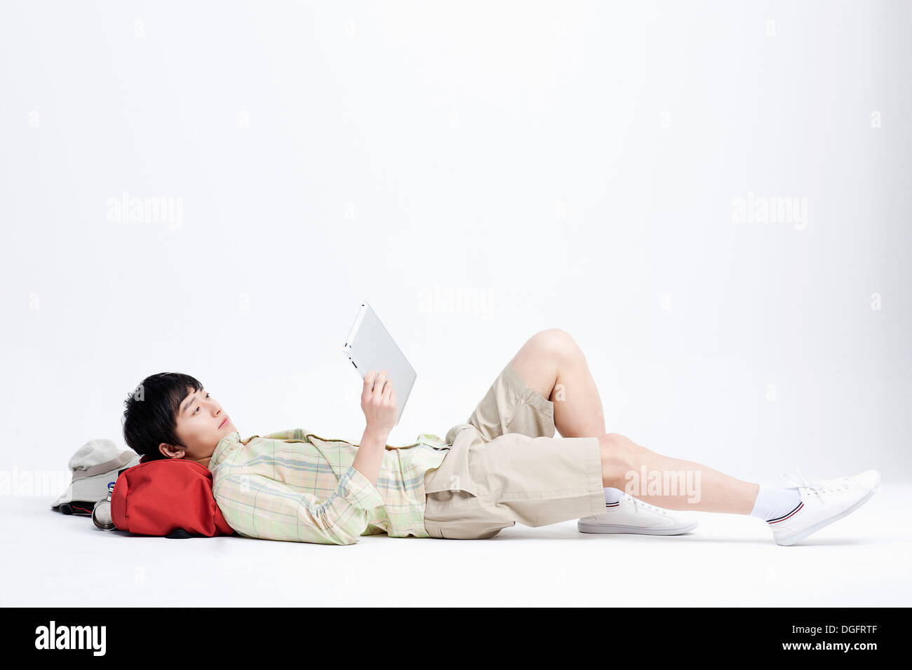 a boy lying on hiking back pack Stock Photo