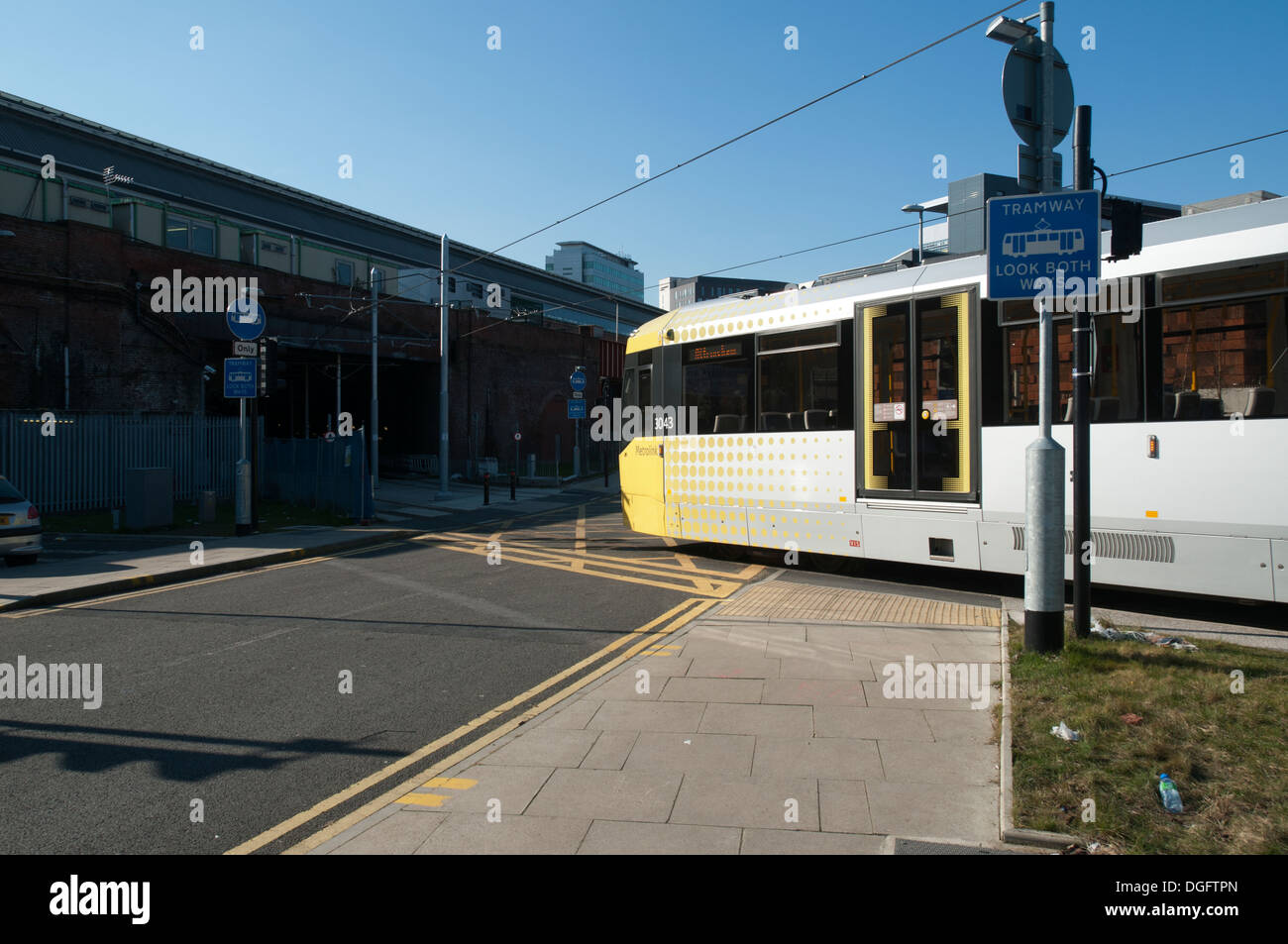 A Metrolink tram crossing Sheffield Street, near Piccadilly Station