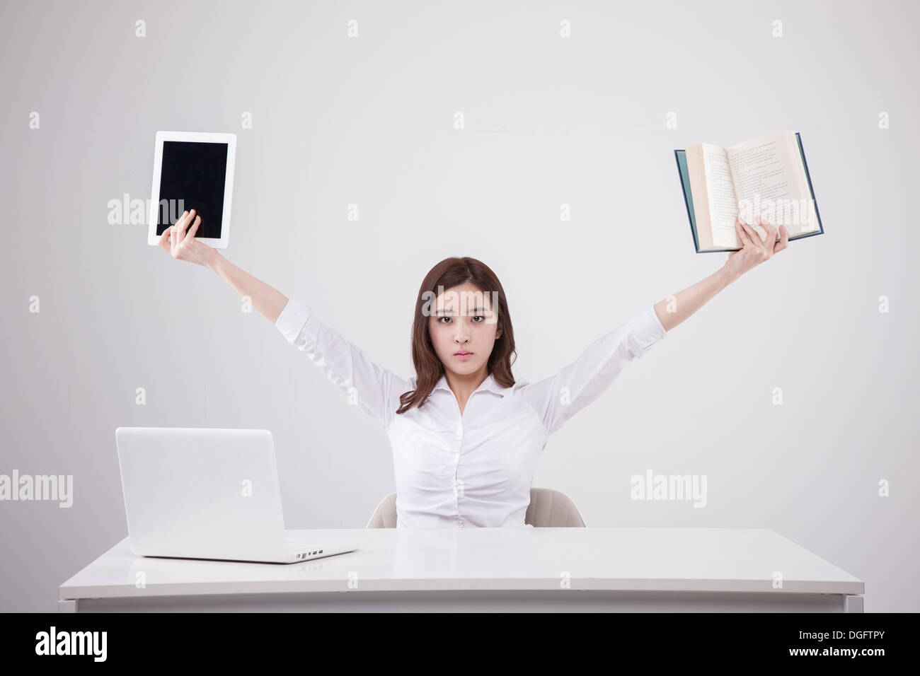 a business woman holding a tablet and a book Stock Photo