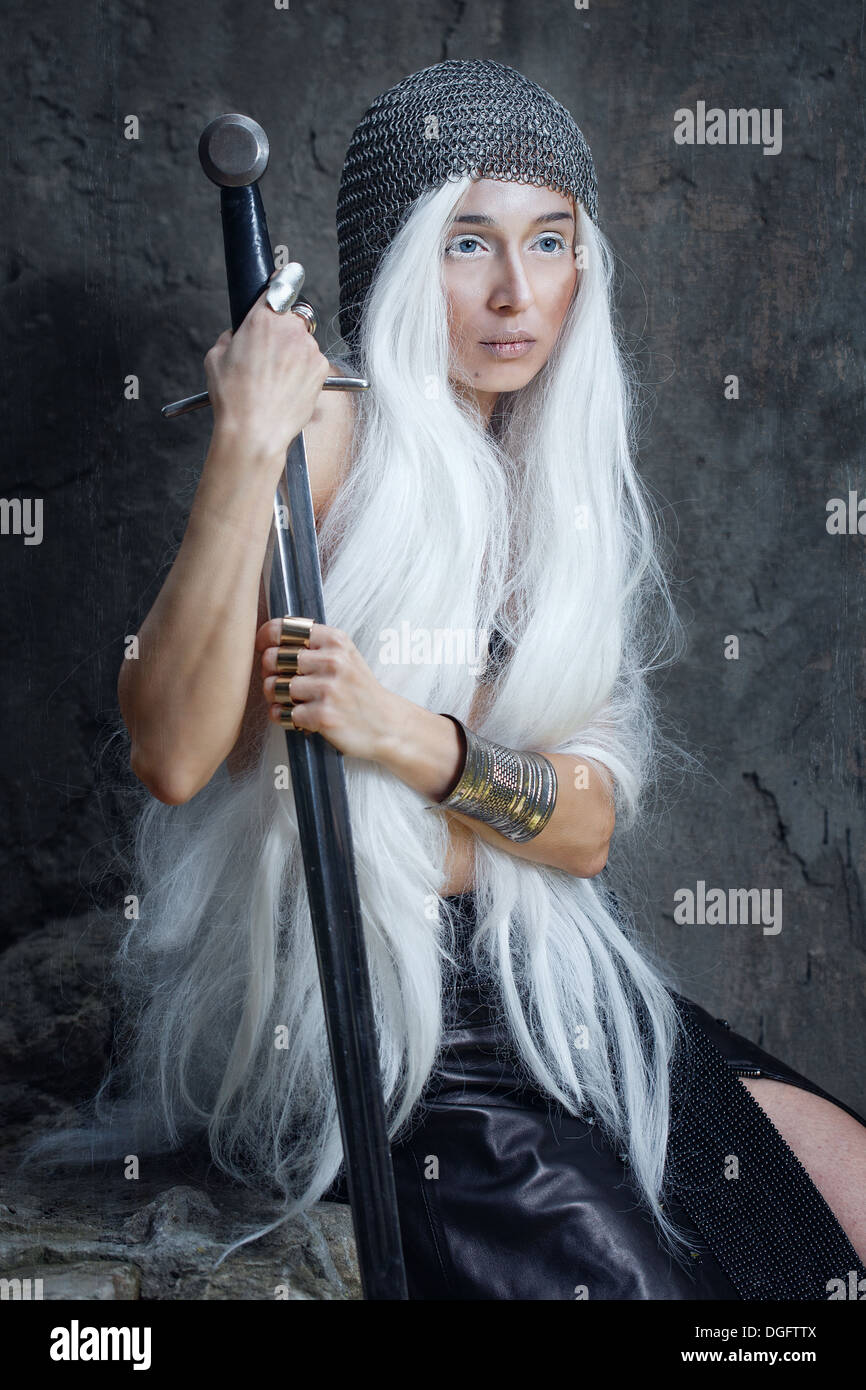 Girl with long white hair in chain mail and sword Stock Photo