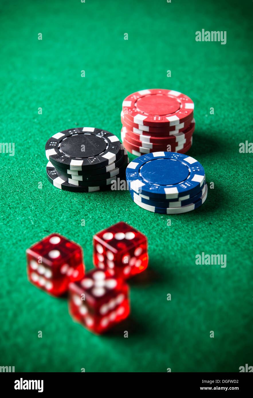 piles of poker chips next to dices Stock Photo Alamy