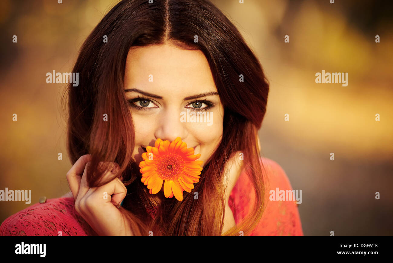 Girl with a flower in his mouth Stock Photo Alamy