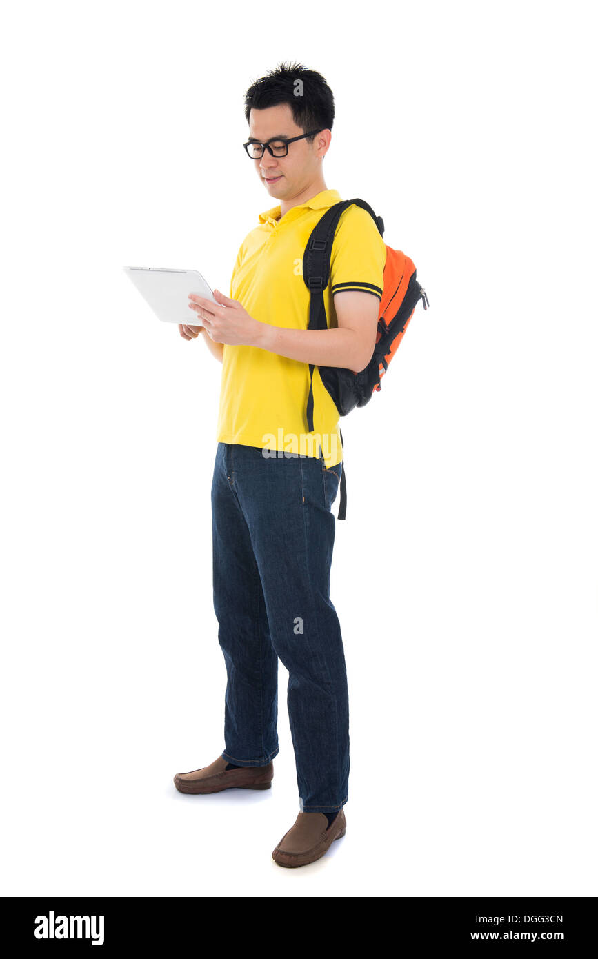 Young Asian student using pad PC isolated on white background. Stock Photo