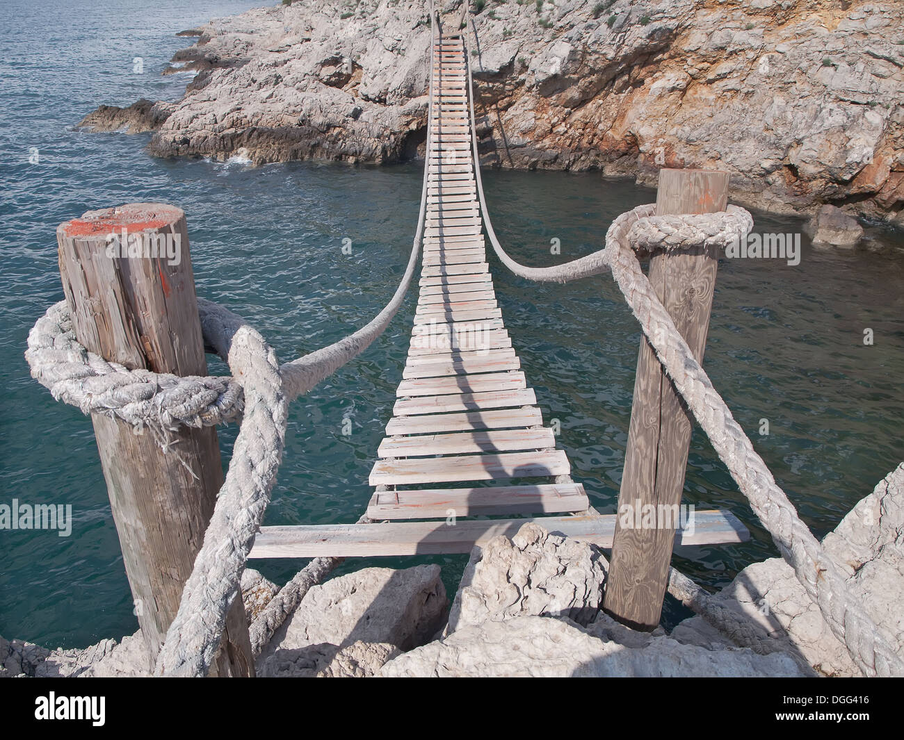 hanging wooden bridge connect rocky seacost Stock Photo Alamy