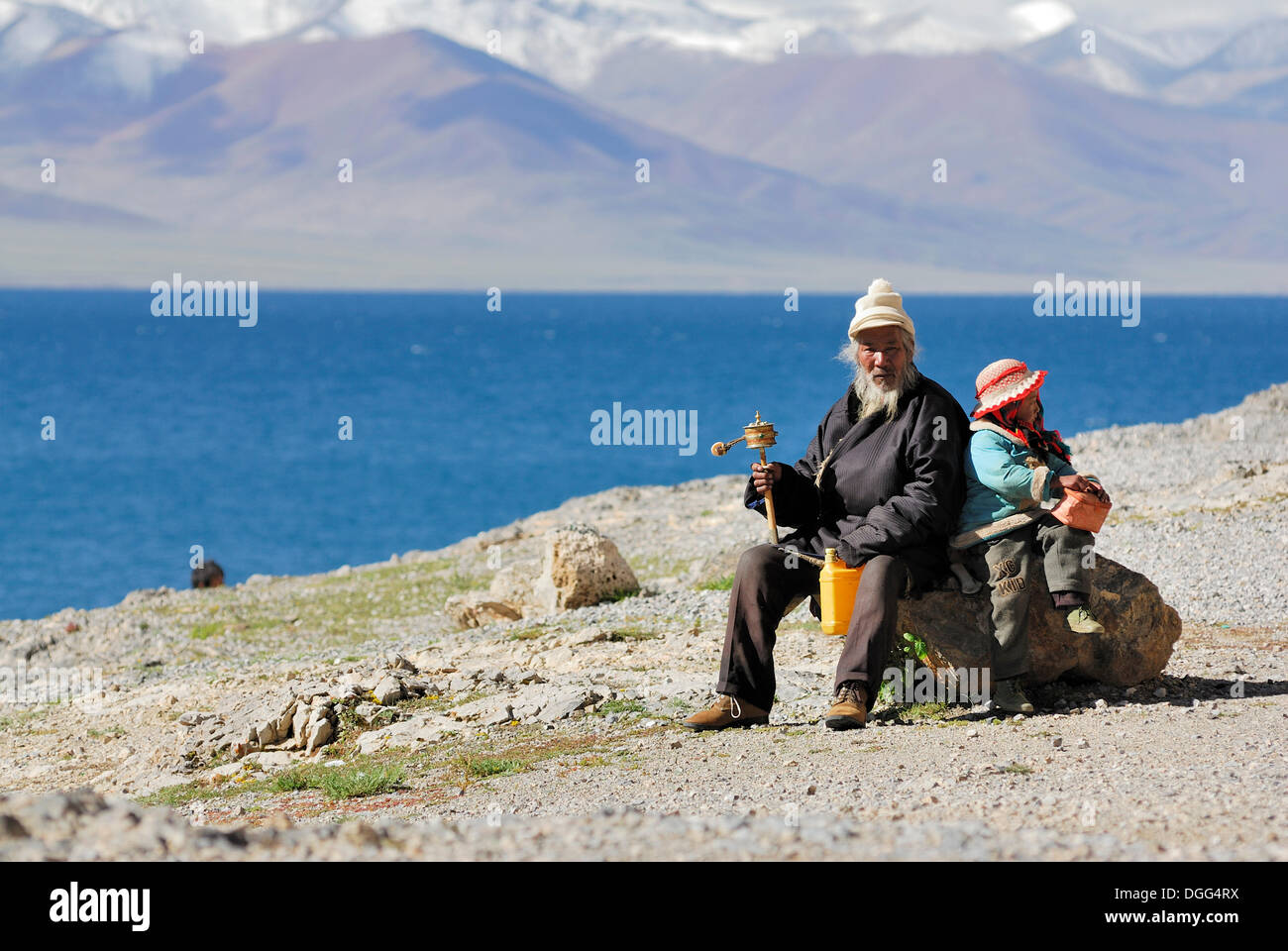 Tibetan pilgrim with prayer wheel at Namtso Lake, Heavenly Lake, Tibet, China, Asia Stock Photo