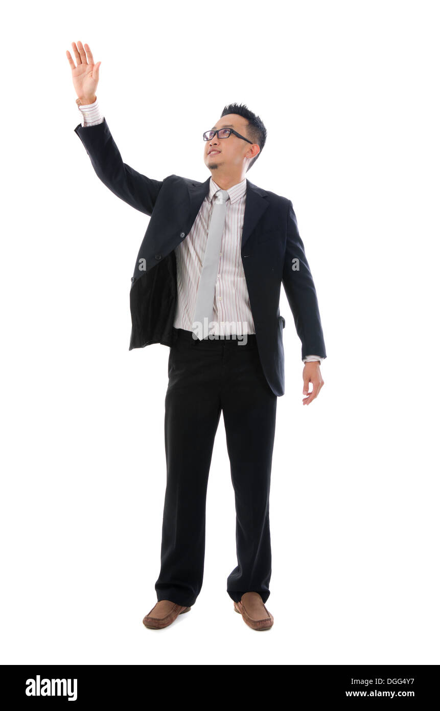Business man touching an imaginary screen or button on white background Stock Photo
