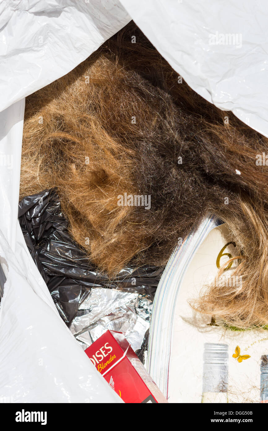 Discarded human hair and rubbish. Salisbury streets England UK Stock Photo