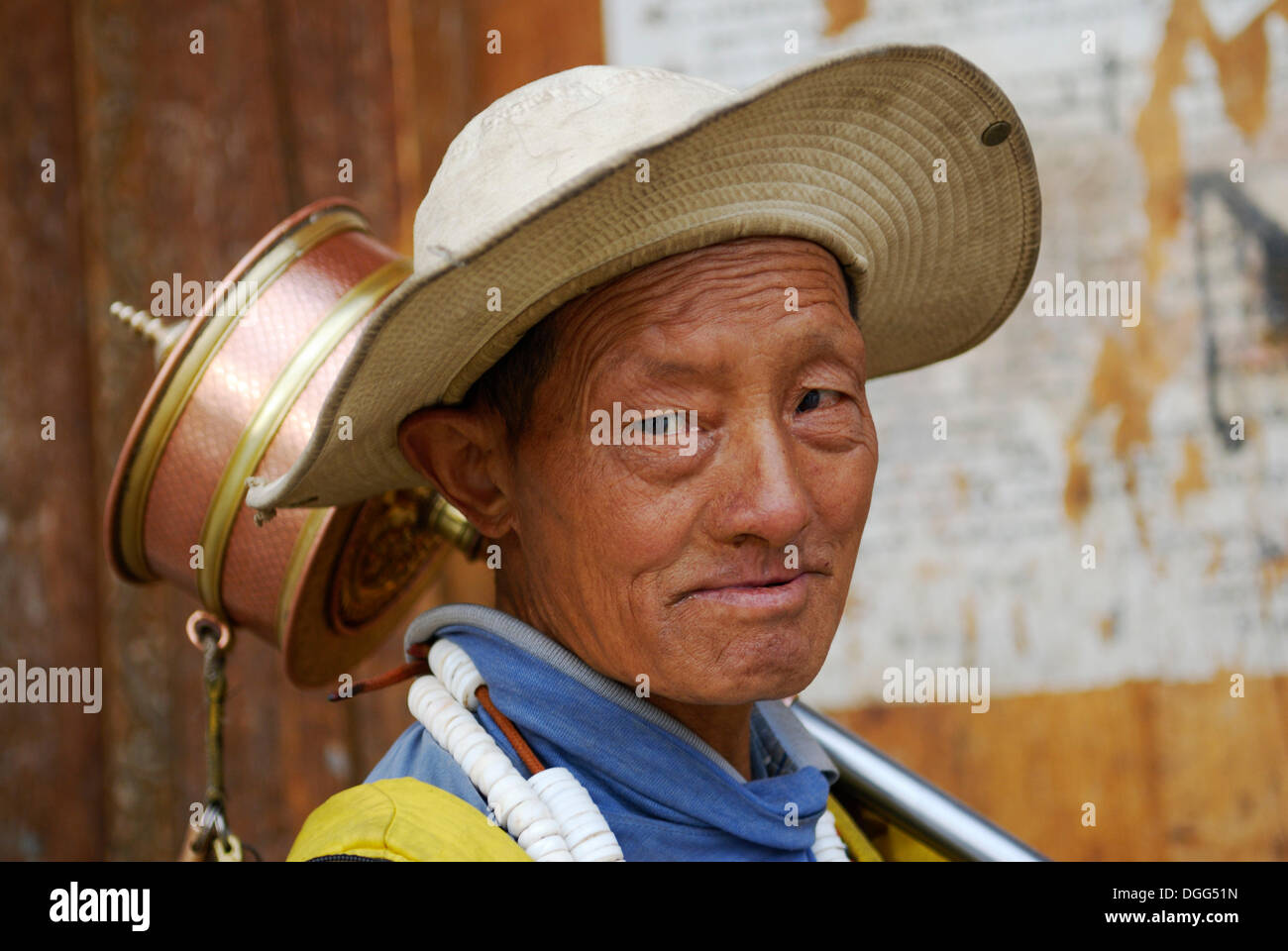 Tibetan pilgrim with a prayer wheel, portrait, main gate, Samye Monastery, Tibet, China, Asia Stock Photo