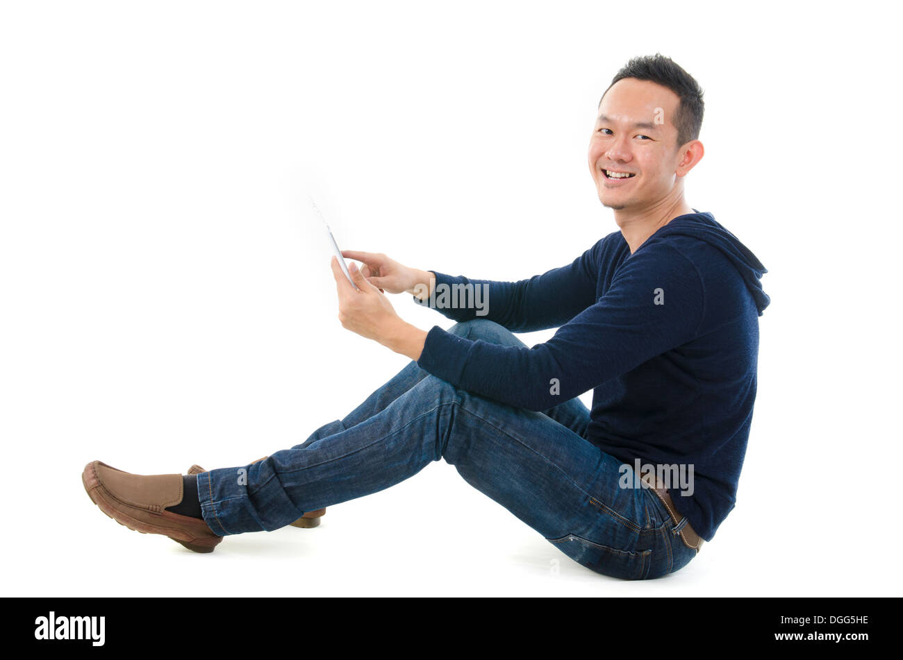 Young Asian student using pad PC isolated on white background. Stock Photo