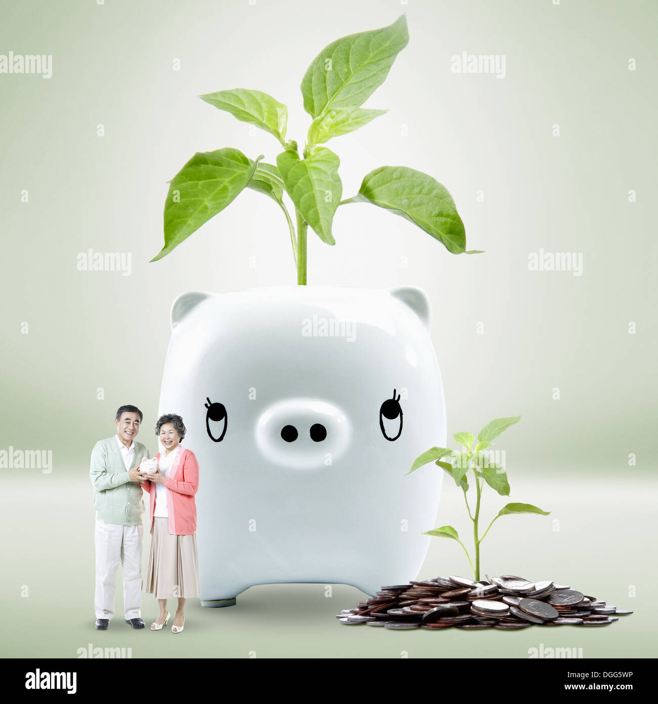 an old couple in front of a piggy bank Stock Photo - Alamy