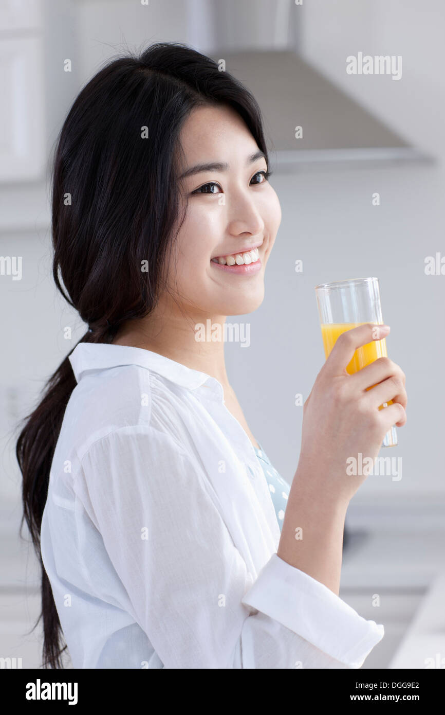a young woman drinking juice Stock Photo Alamy