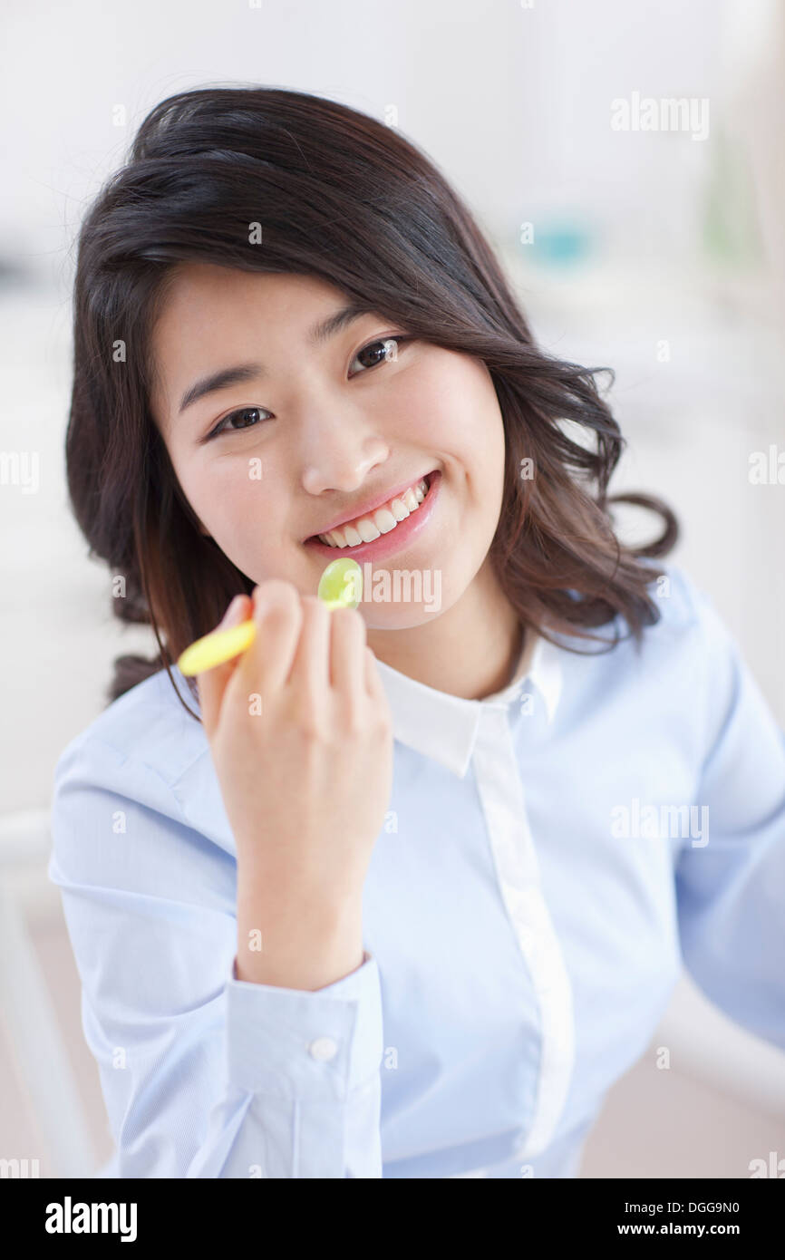a young woman eating breakfast and working Stock Photo
