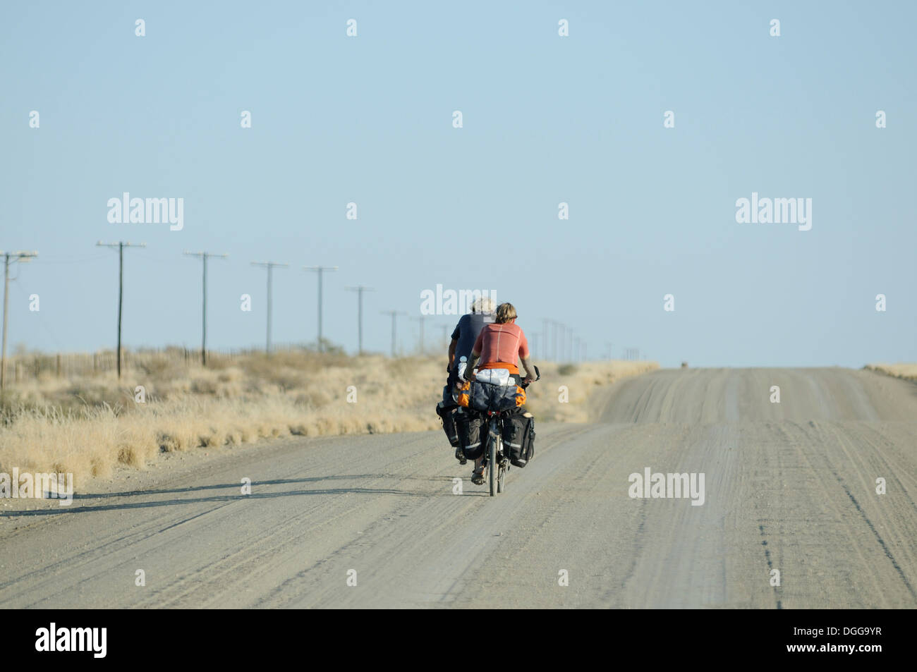 Cyclists on a dusty track, Karas Region, Namibia Stock Photo