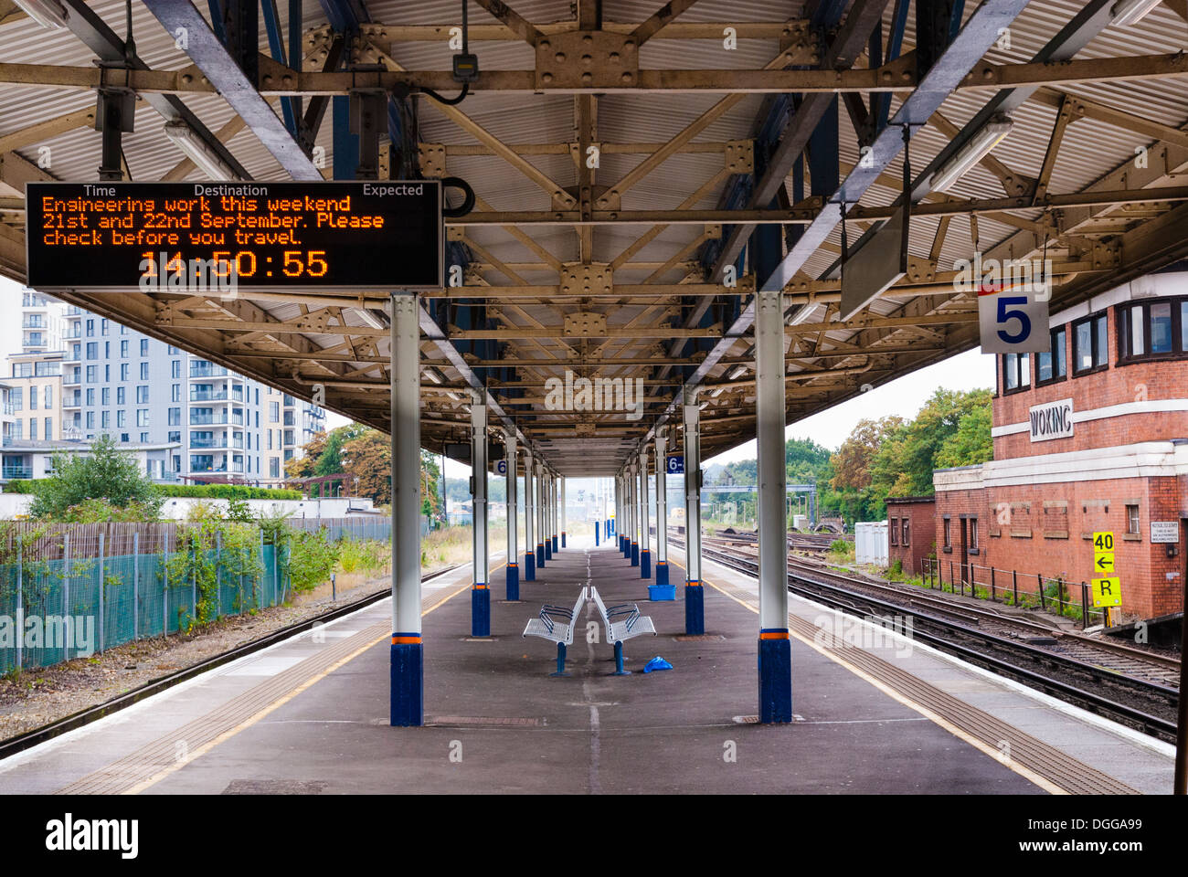 Empty platform at Woking station with engineering work electronic sign. Stock Photo