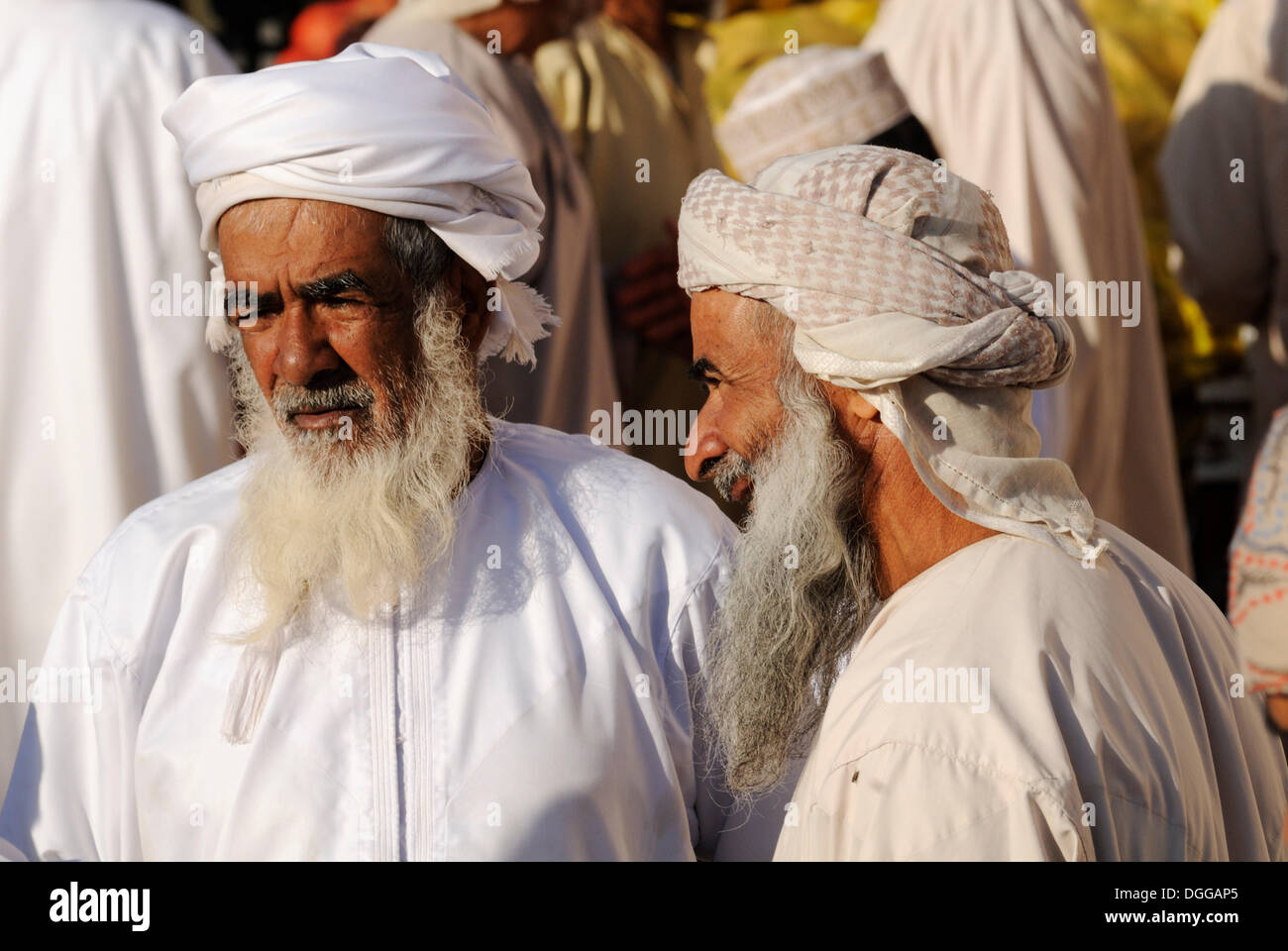 Omani men in traditional dress, livestock or animal market at Nizwa, Hajar al Gharbi Mountains, Al Dakhliyah region Stock Photo