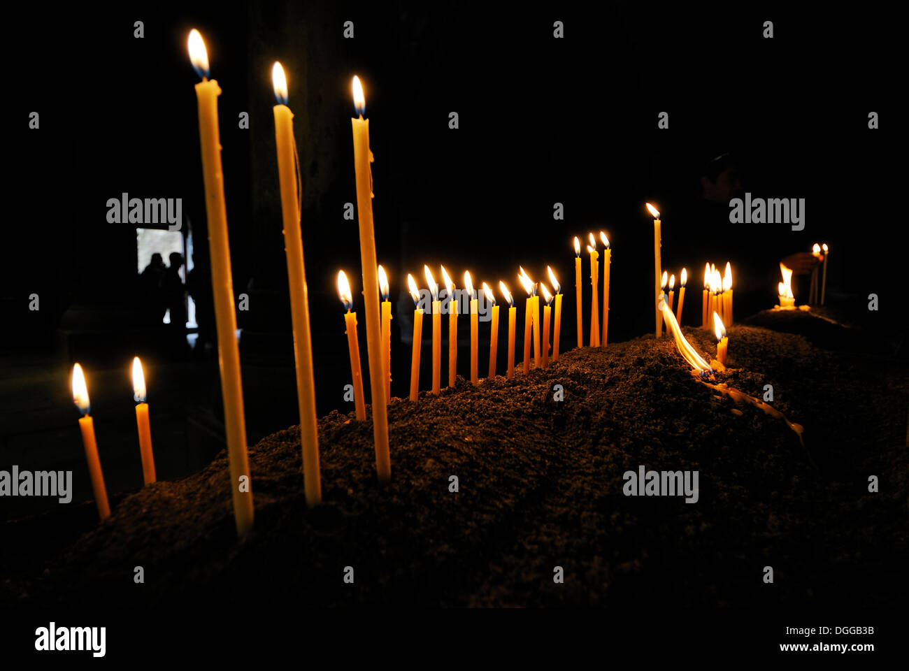 Candles burning in the Armenian orthodox church at Geghard monastery near Garni, UNESCO World Heritage Site, Kotayk region Stock Photo