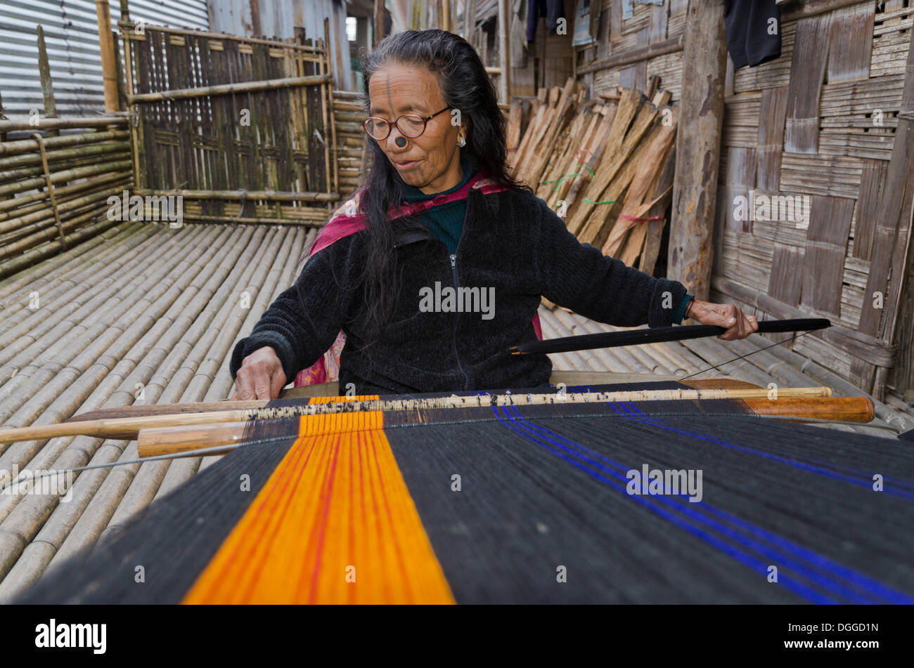 Apatani woman weaving material on a traditional hand loom, Hani, India, Asia Stock Photo
