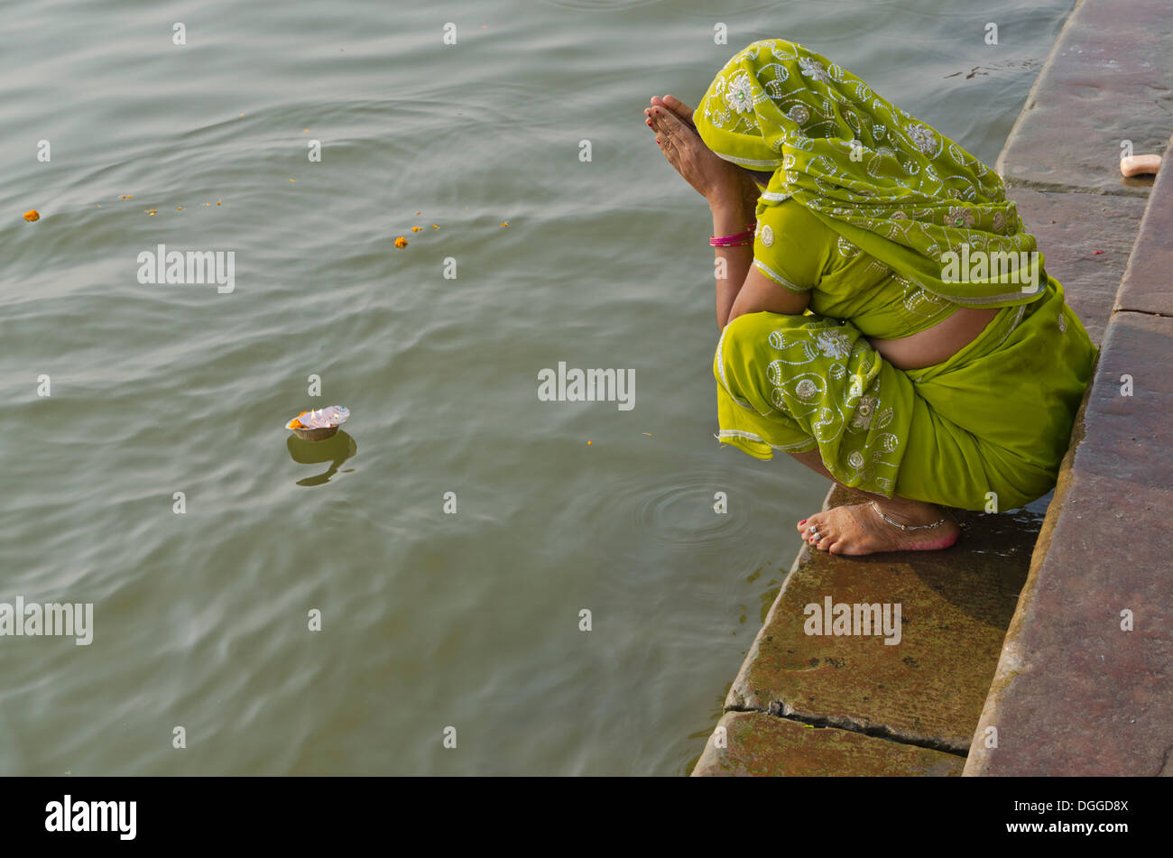 Woman offering a Deepak to the holy river Ganges, Varanasi, India, Asia Stock Photo