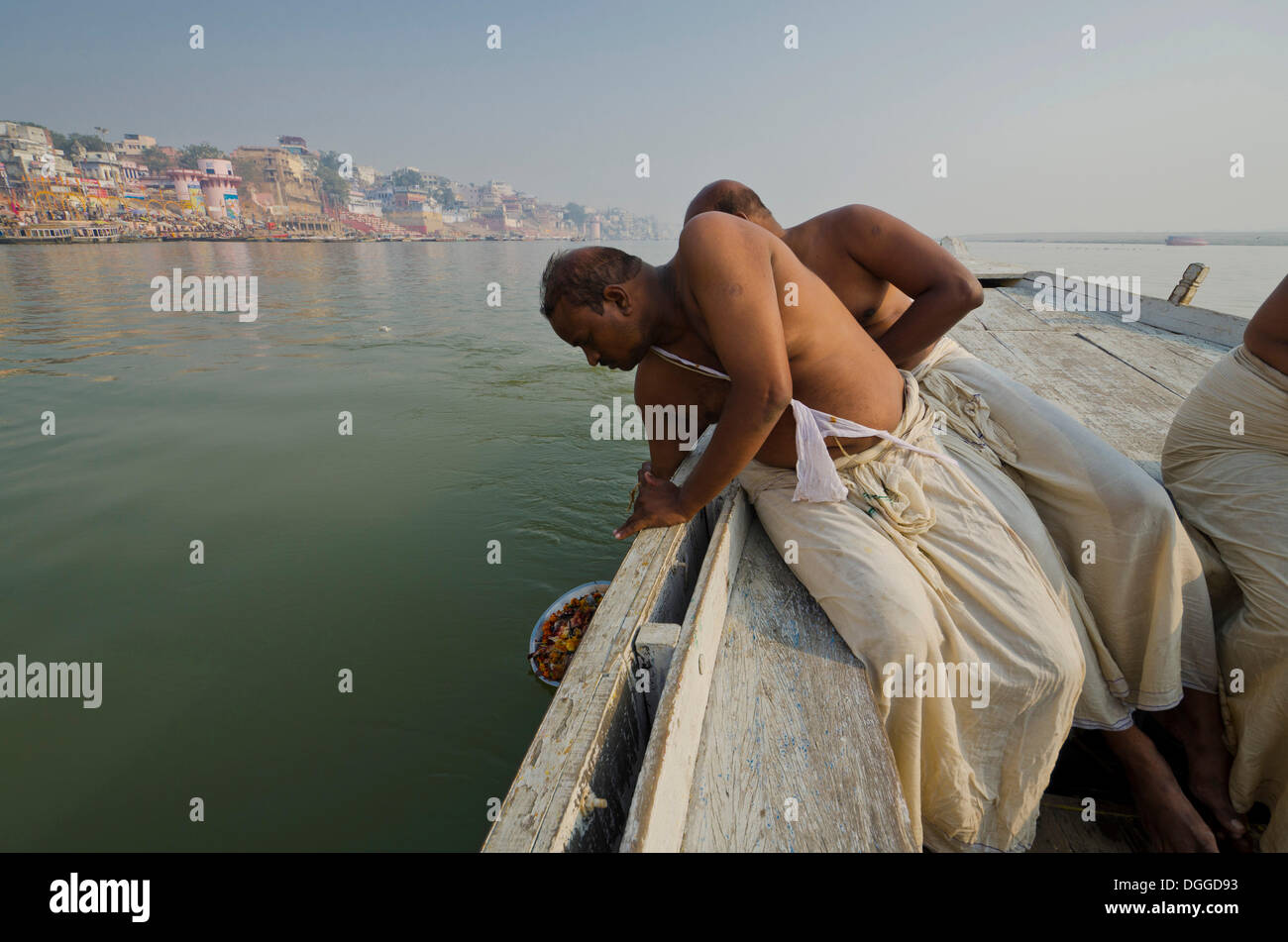 Remains of the cremation of a family member are offered to the holy river Ganges, Varanasi, India, Asia Stock Photo