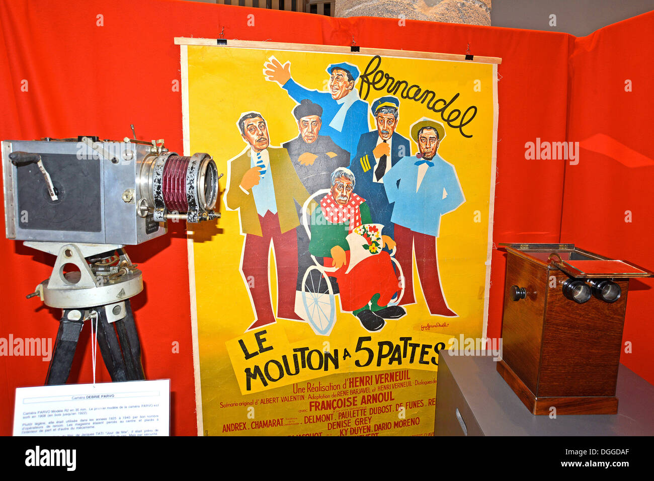 Debrie Parvo camera R2 model 35 mm 1924 ( left ) and cinema poster : ' Le mouton à 5 pattes ' film of Henri Verneuil with Fernandel Stock Photo