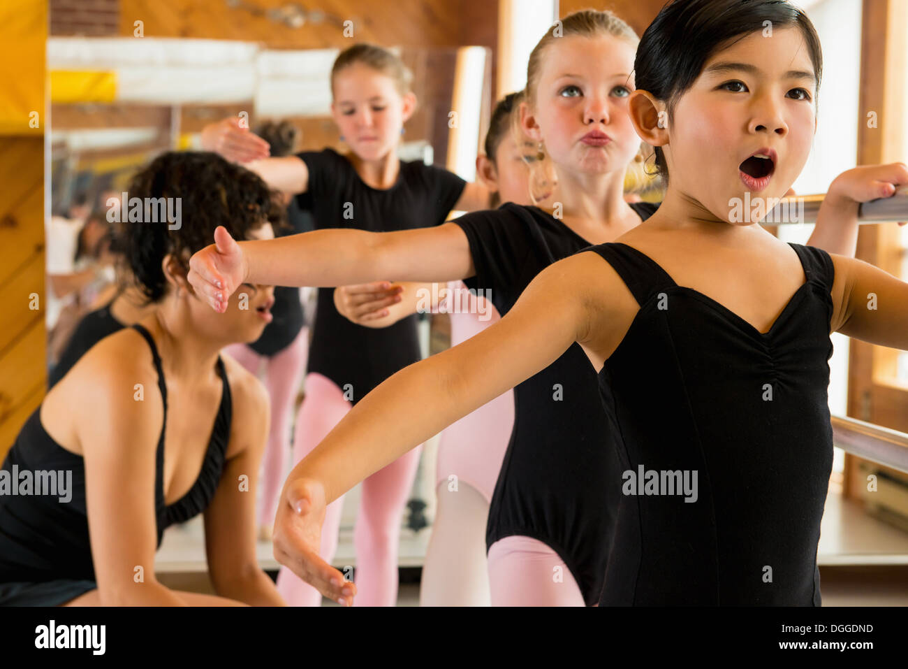 Ballerinas practising at the barre in ballet school Stock Photo