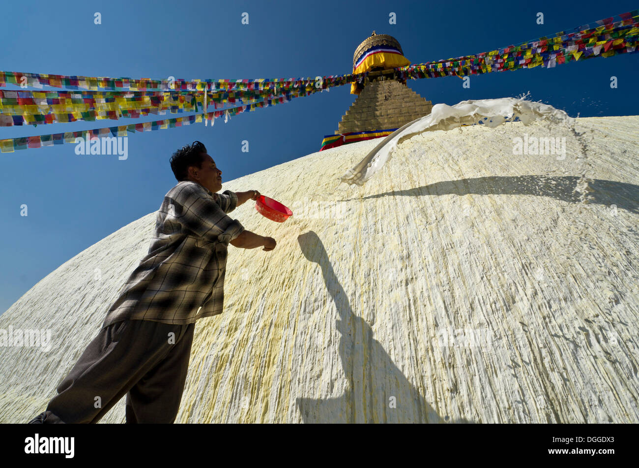 Worker renewing the white paint of Boudnath Stupa, Kathmandu Valley, Kathmandu, Kathmandu District, Bagmati Zone, Nepal Stock Photo