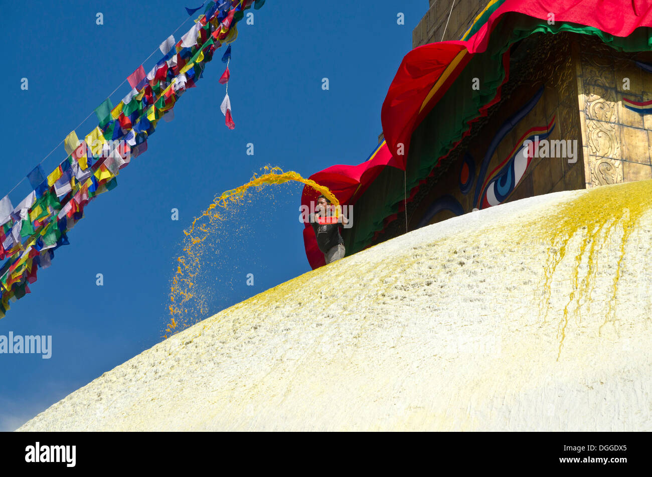 Worker renewing the yellow paint of Boudnath Stupa, Kathmandu Valley, Kathmandu, Kathmandu District, Bagmati Zone, Nepal Stock Photo