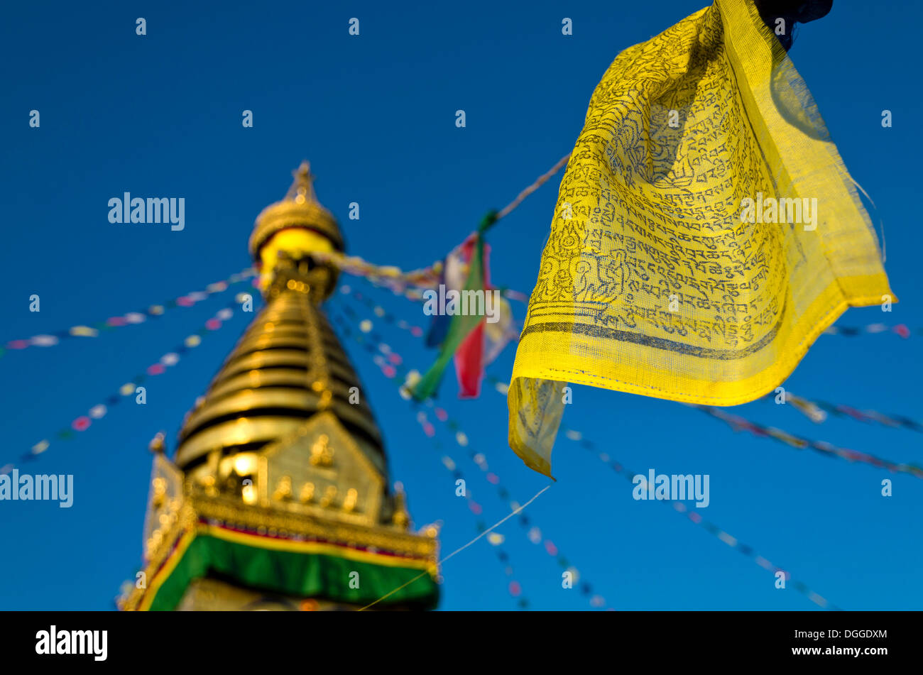 Yellow Buddhist prayer flag with Swayambhunath Stupa, Monkey Temple, Kathmandu Valley, Kathmandu, Kathmandu District Stock Photo