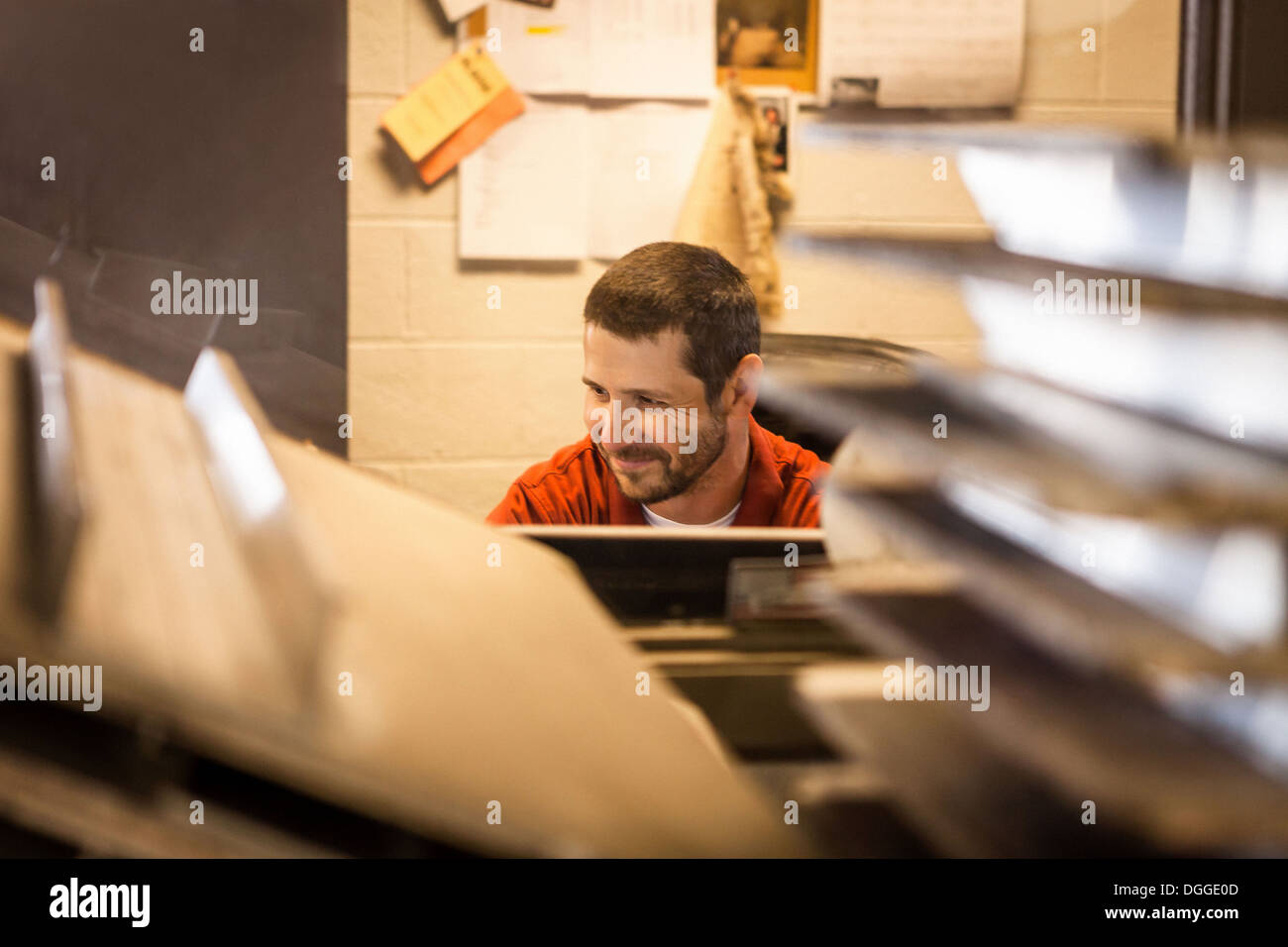 Business owner sitting in warehouse office Stock Photo