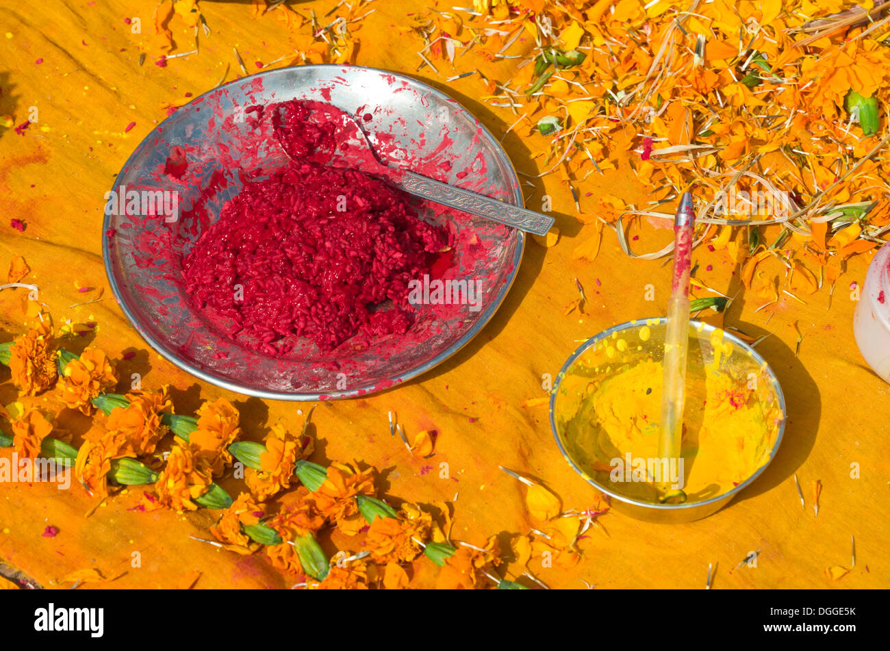 Colourpowder and coloured rice on yellow material to work with as a priest, Kathmandu, Kathmandu District, Bagmati Zone, Nepal Stock Photo