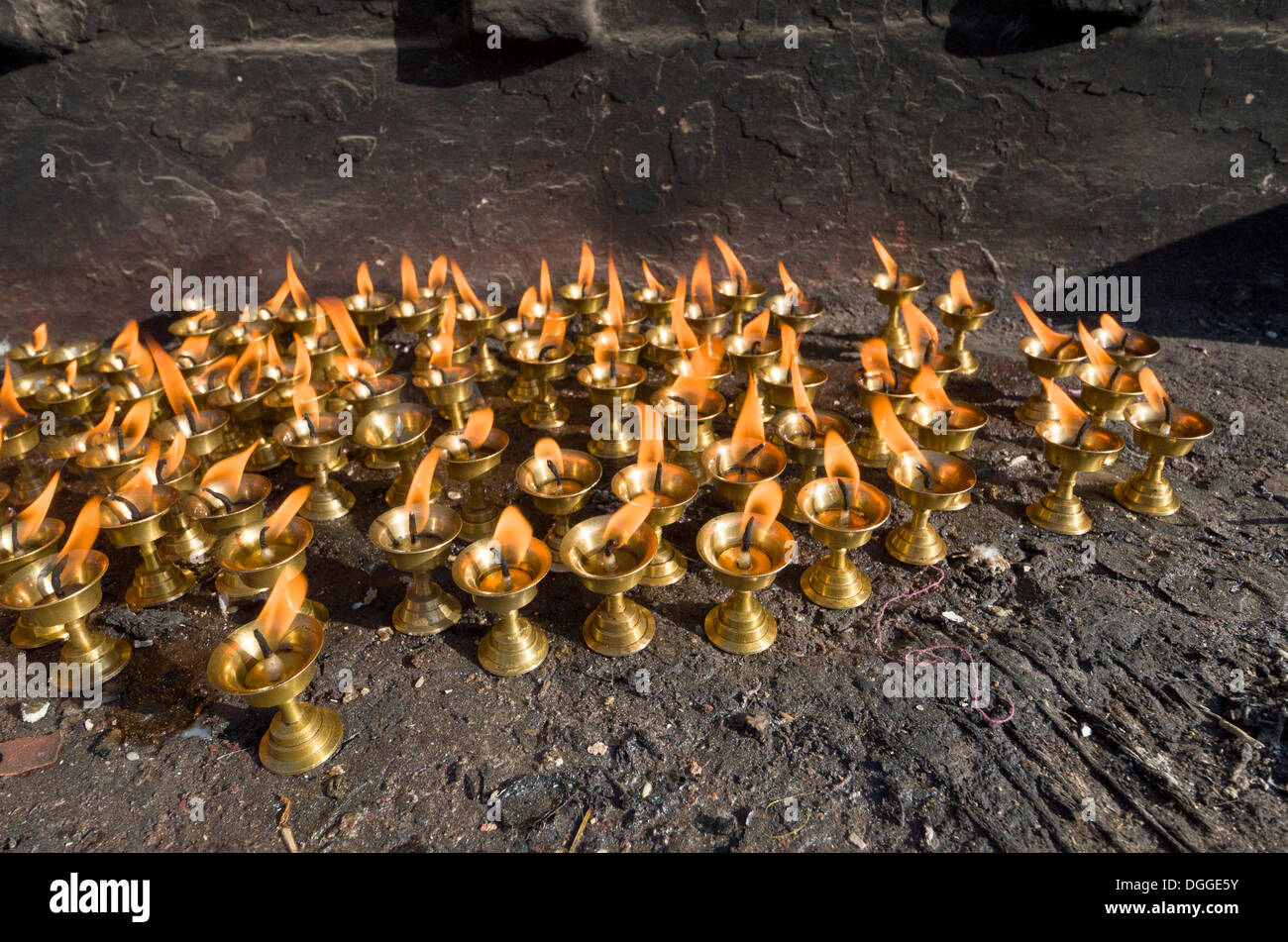 Small butterlamps, lighted, for sale as offerings, Kathmandu, Kathmandu District, Bagmati Zone, Nepal Stock Photo